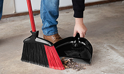 Indoor/Outdoor Angle Broom with Dustpan being used in a garage