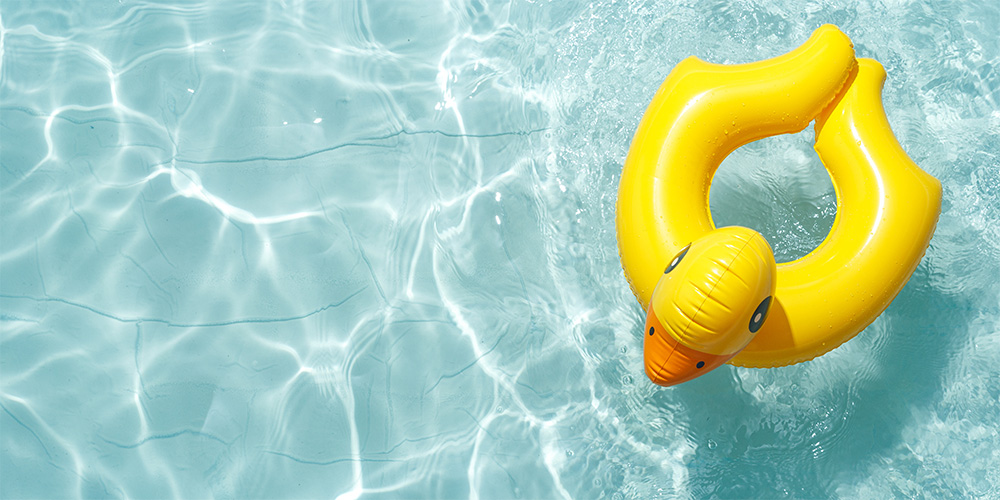 Inflatable duck pool toy floating on pool water