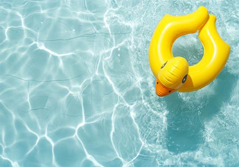 Inflatable ducky pool toy floating on pool water